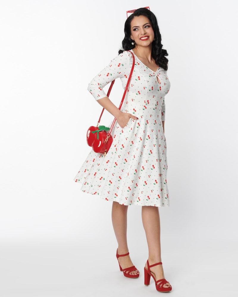 Front of a model wearing a size L Unique Vintage White & Cherry Print Pin Dot Keyhole Neck Swing Dress in White, Polka Dot by Unique Vintage. | dia_product_style_image_id:301077